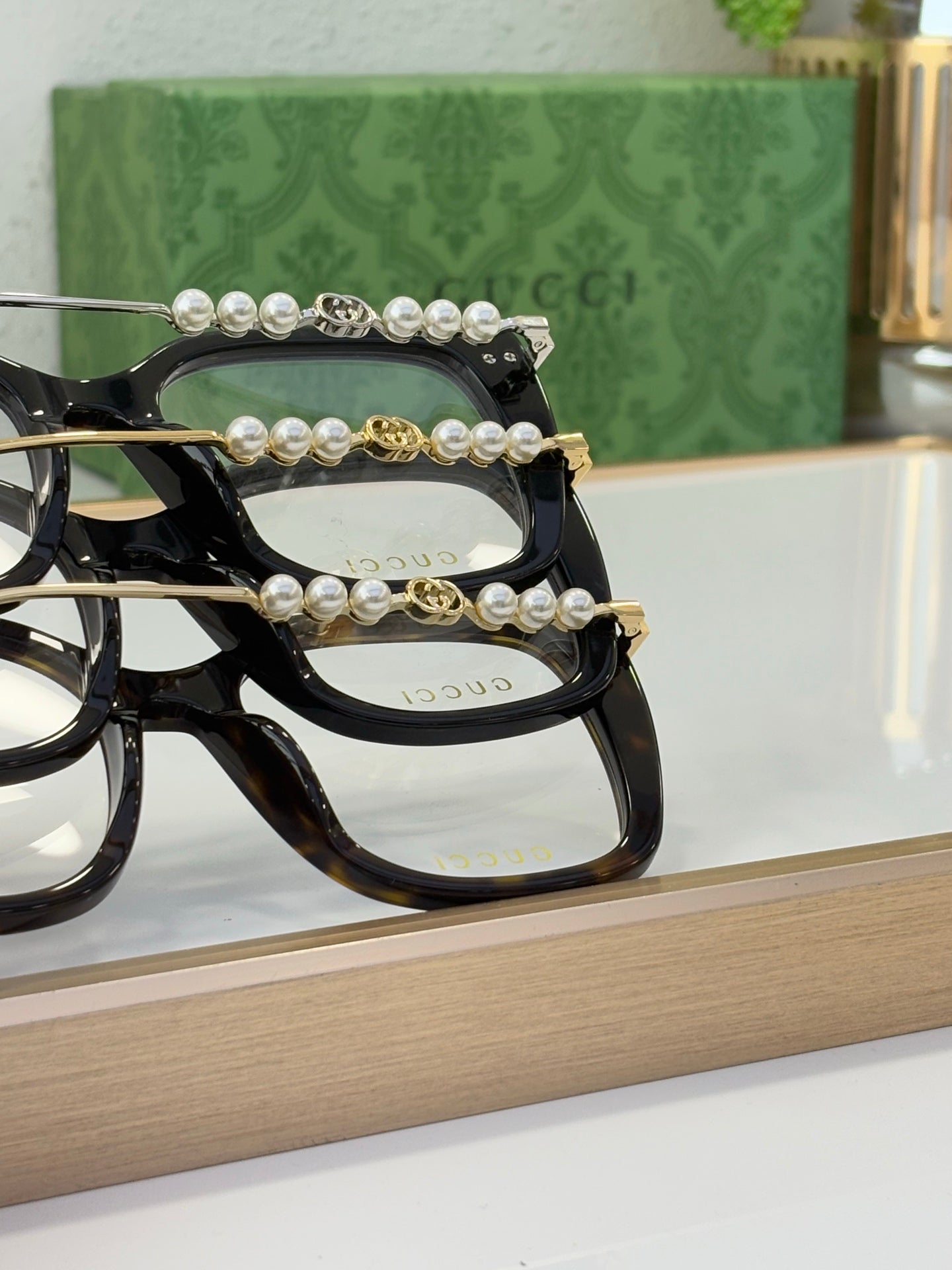 Gucci glasses with black frames and pearl-bead and gold accent temple detail