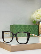 Gucci glasses with dark lenses, black square frames, and pearl-bead temple detail