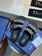 Unisex Dior slide sandals pair with black footbeds and Dior monogram print straps