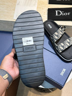 Unisex Dior slide sandal sole with ridged rubber tread and monogram strap