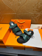 Hermes green double-strap sandals with adjustable look and black rubber soles