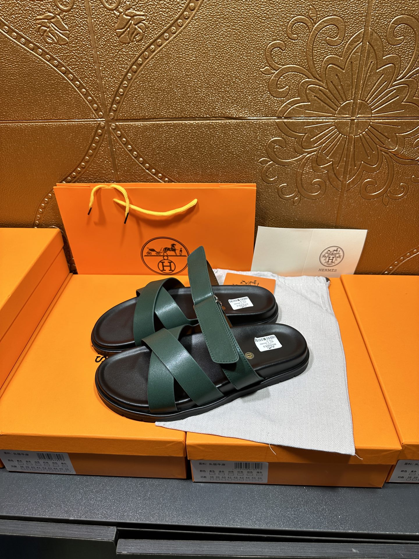 Hermes teal slide sandals with two wide crossing straps and black footbed