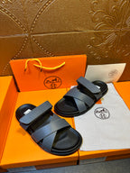 Hermes slide sandals with two navy straps and black footbed, side view