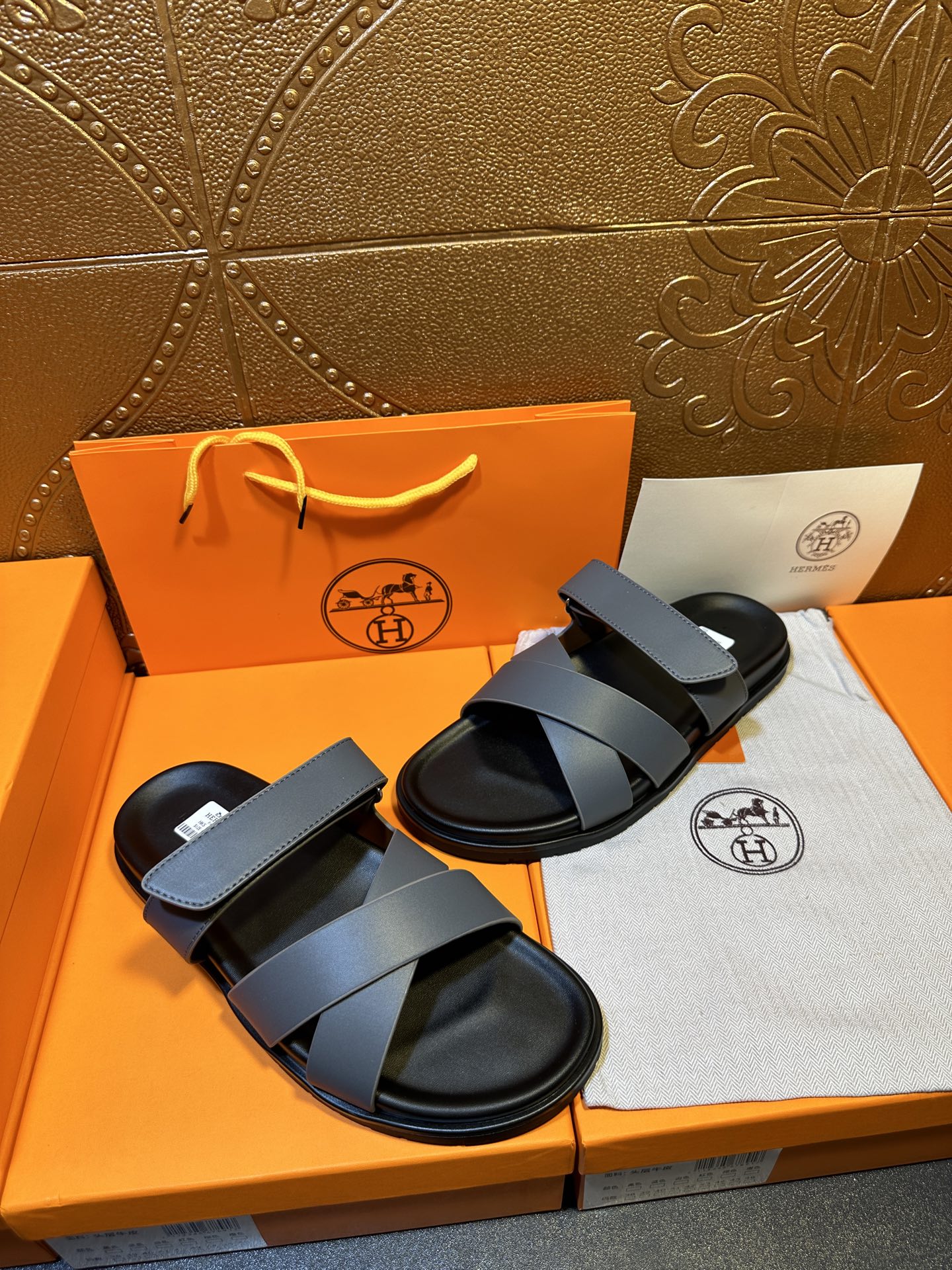 Hermes slide sandals with two navy straps and black footbed, side view