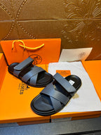 Hermes slide sandals with wide navy band straps and black soles