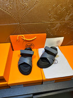 Hermes slide sandals with two navy bands and black sole, paired