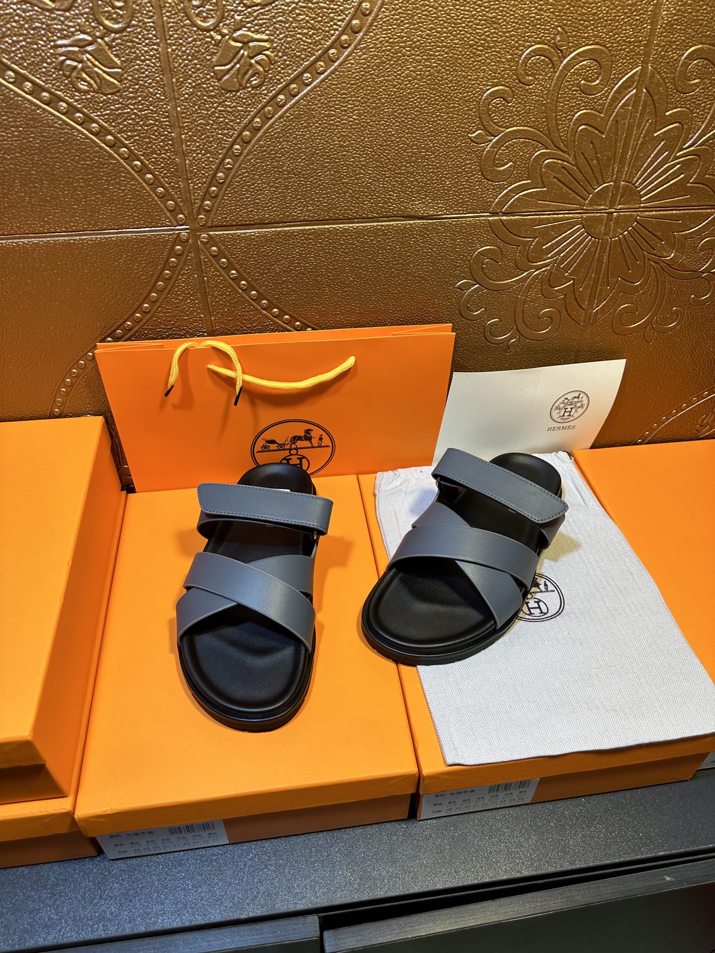 Hermes slide sandals with two navy bands and black sole, paired