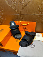Black leather sandals with thick cross straps and open-toe design