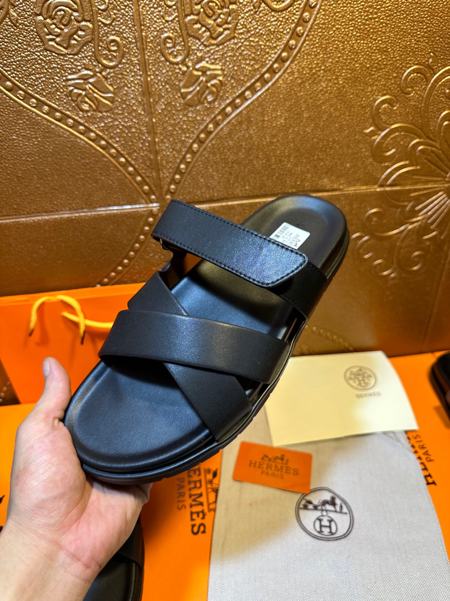 Black leather slide sandals with wide top strap and side buckle detail