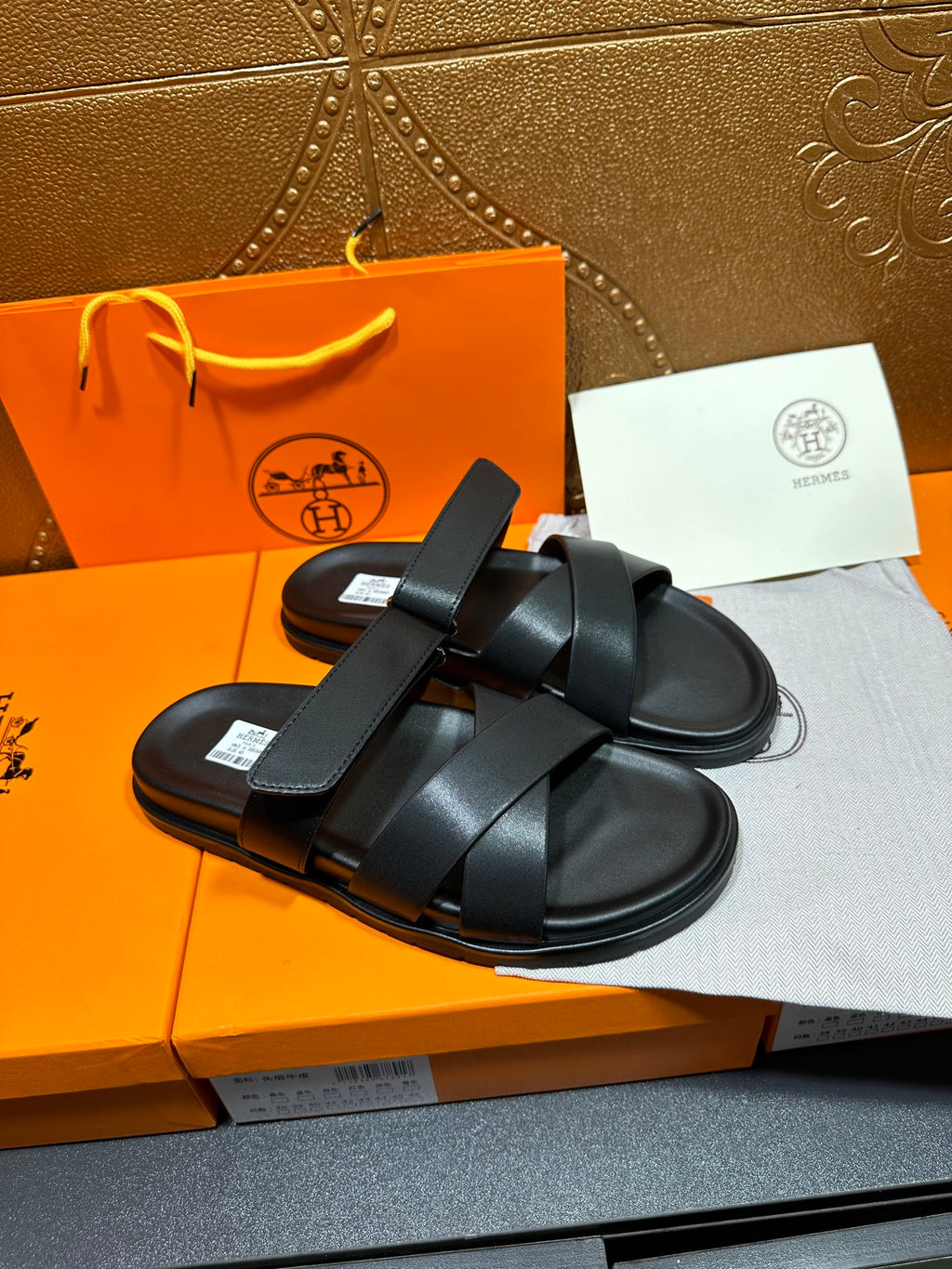 Black leather sandals with thick cross straps and textured footbed