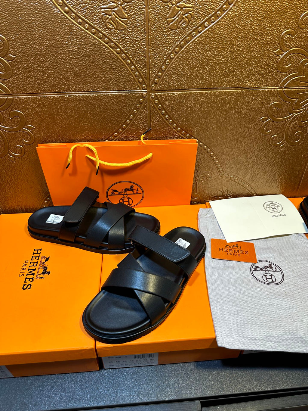 Black leather sandals with stacked cross straps and open-toe silhouette