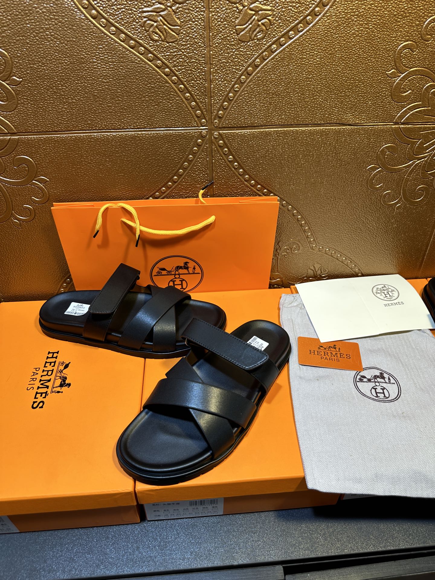 Black leather sandals with stacked cross straps and open-toe silhouette