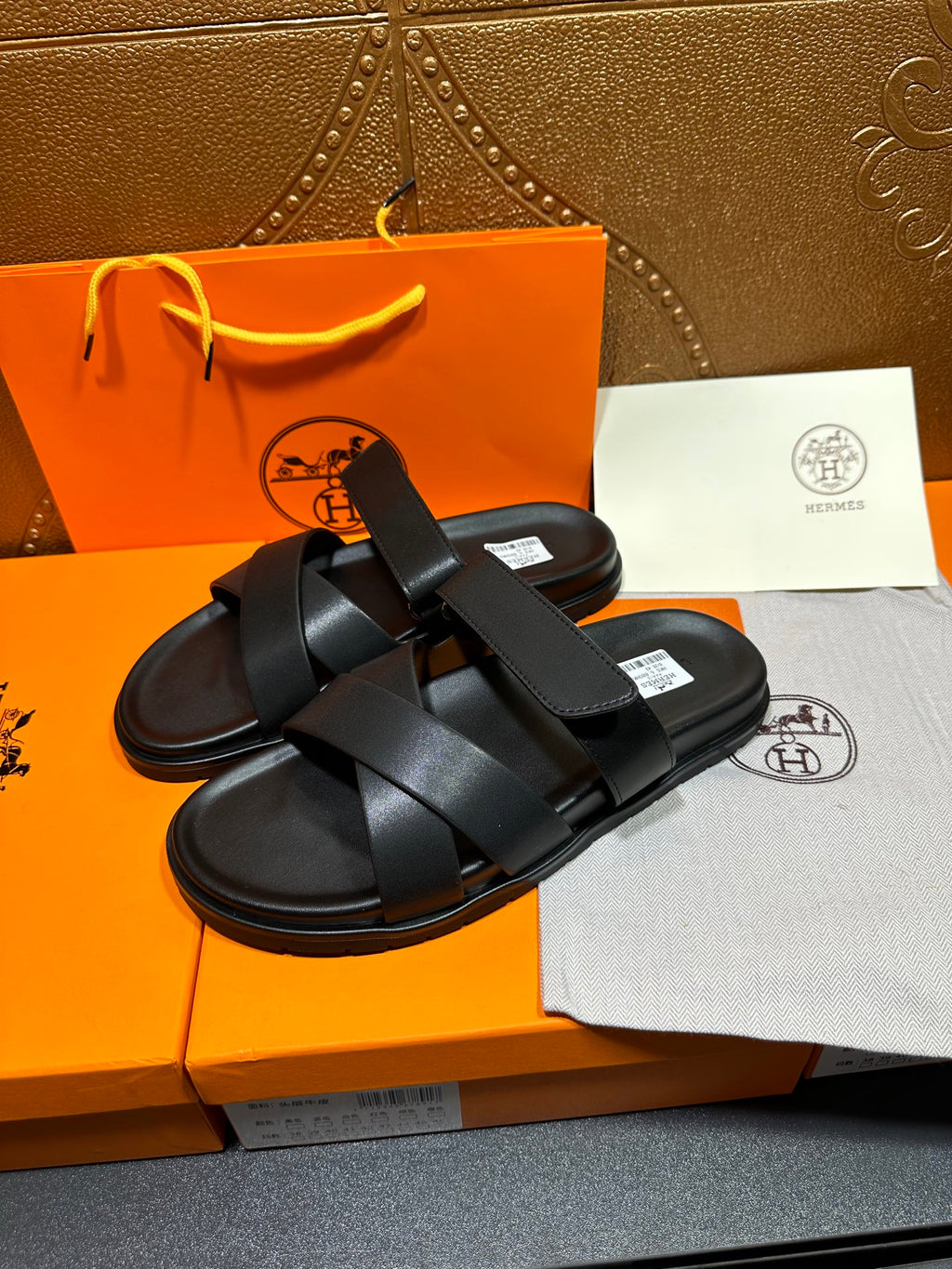 Black slide sandals with wide cross straps and open-toe design