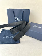 Leather belt with navy strap, dark rectangular buckle, and punched adjustment holes