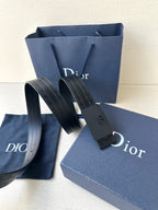 Leather belt with navy strap and dark buckle; packaged with a Dior gift bag