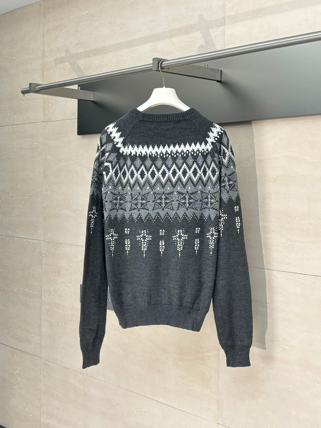 Long-sleeve knit sweater in dark gray with white fair isle pattern, rear view