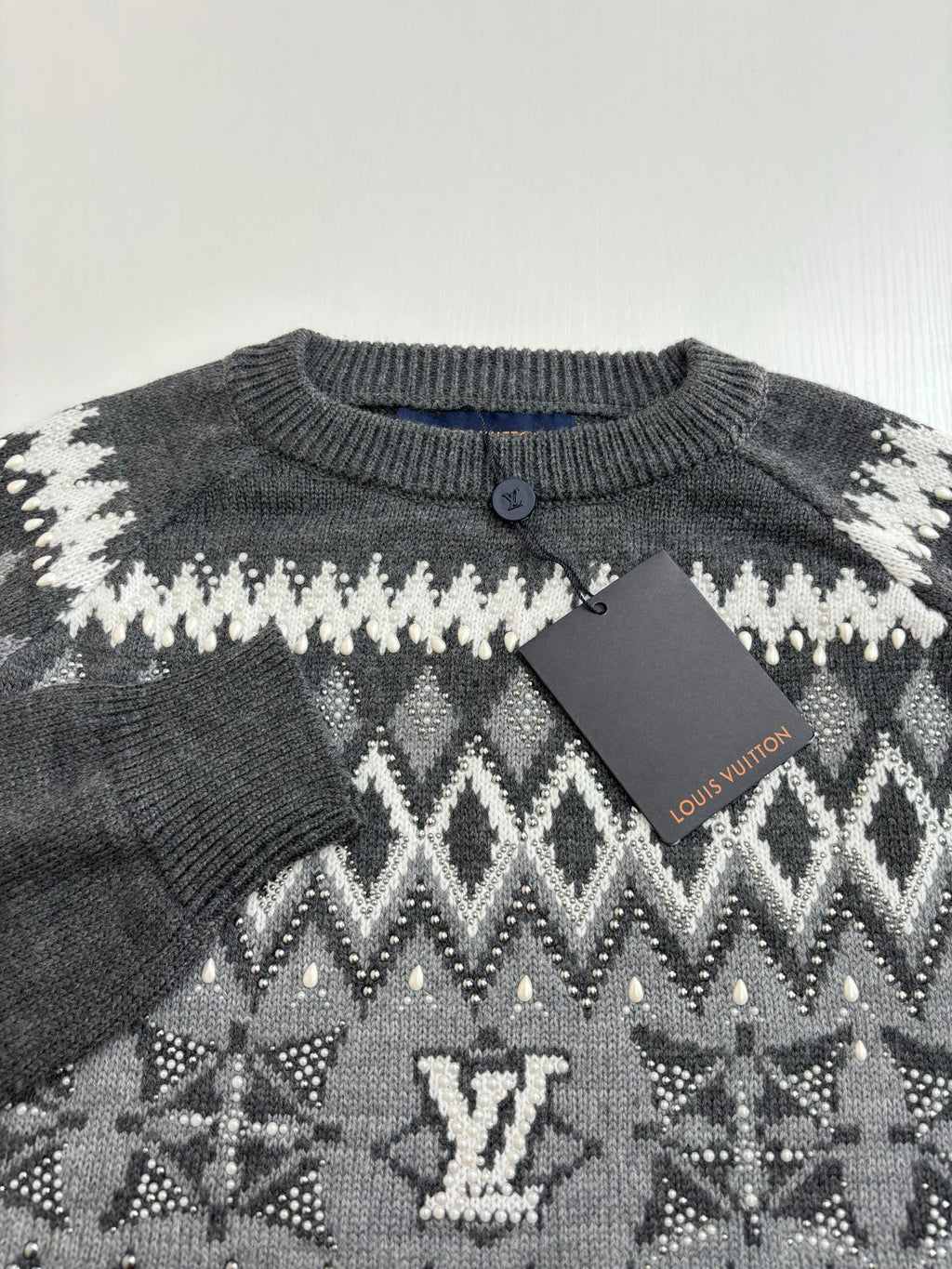 Knit sweater neckline with button placket; dark gray with white pattern and LV detail