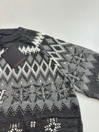 Dark gray knit sweater with white fair isle pattern and small decorative motifs