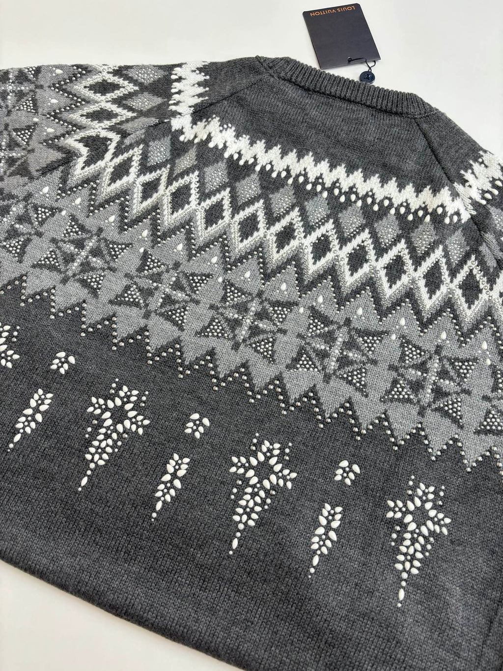 Dark gray knit sweater back with white zigzag fair isle pattern; Louis Vuitton tag