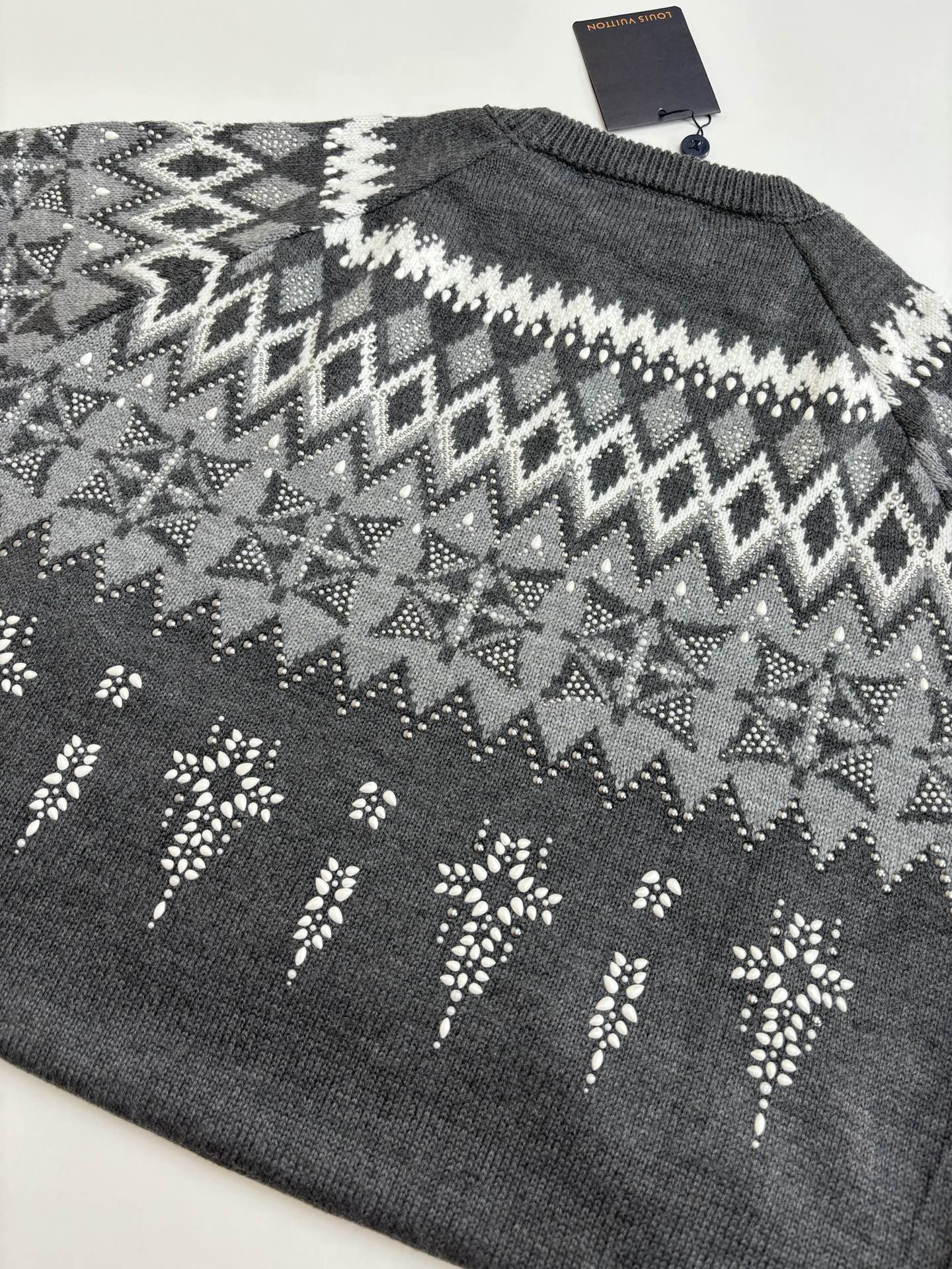Dark gray knit sweater back with white zigzag fair isle pattern; Louis Vuitton tag