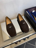 Brown suede loafers with Prada logo strap and stitched moccasin details