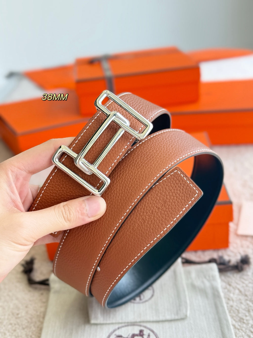 Tan leather belt with silver buckle hardware, 38mm strap