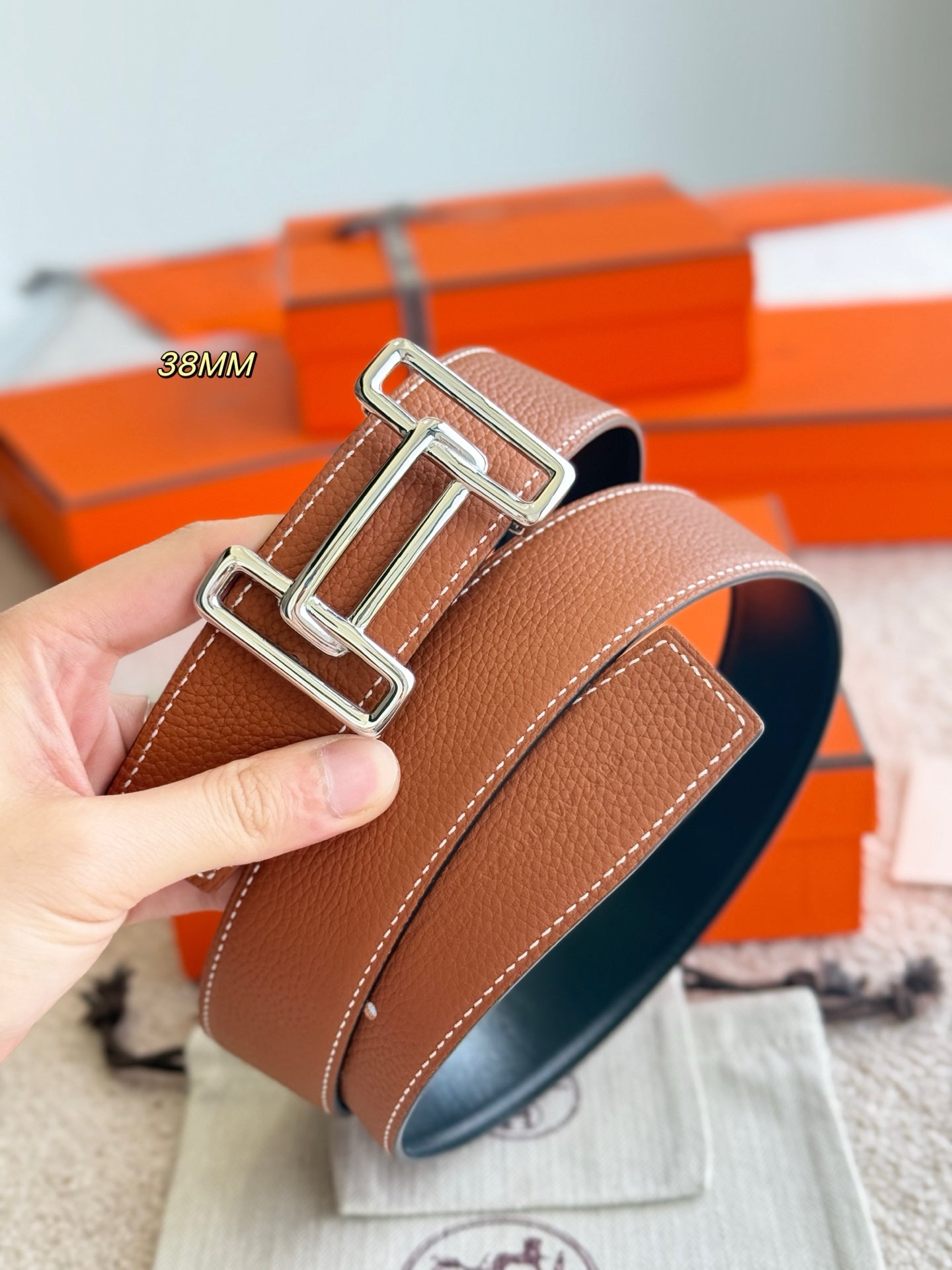 Tan leather belt with silver buckle hardware, 38mm strap