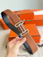 Tan leather belt with silver buckle close-up, 38mm strap