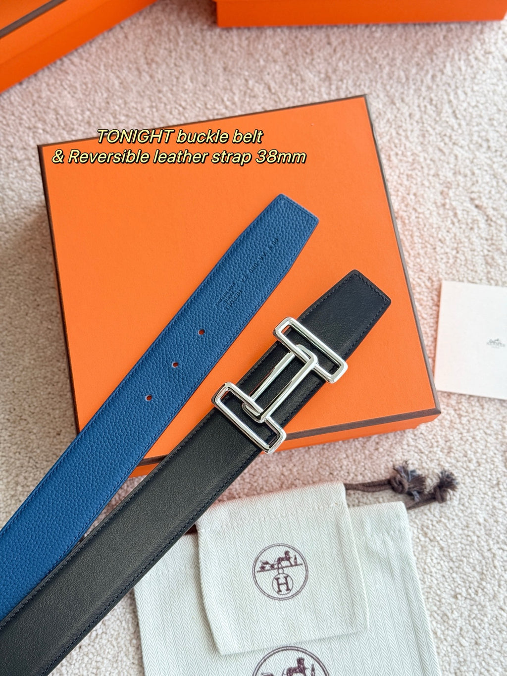 Hermes reversible leather belt showing blue and dark straps with silver double-prong buckle