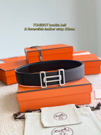 Hermes belt in dark leather with silver-toned buckle, front view