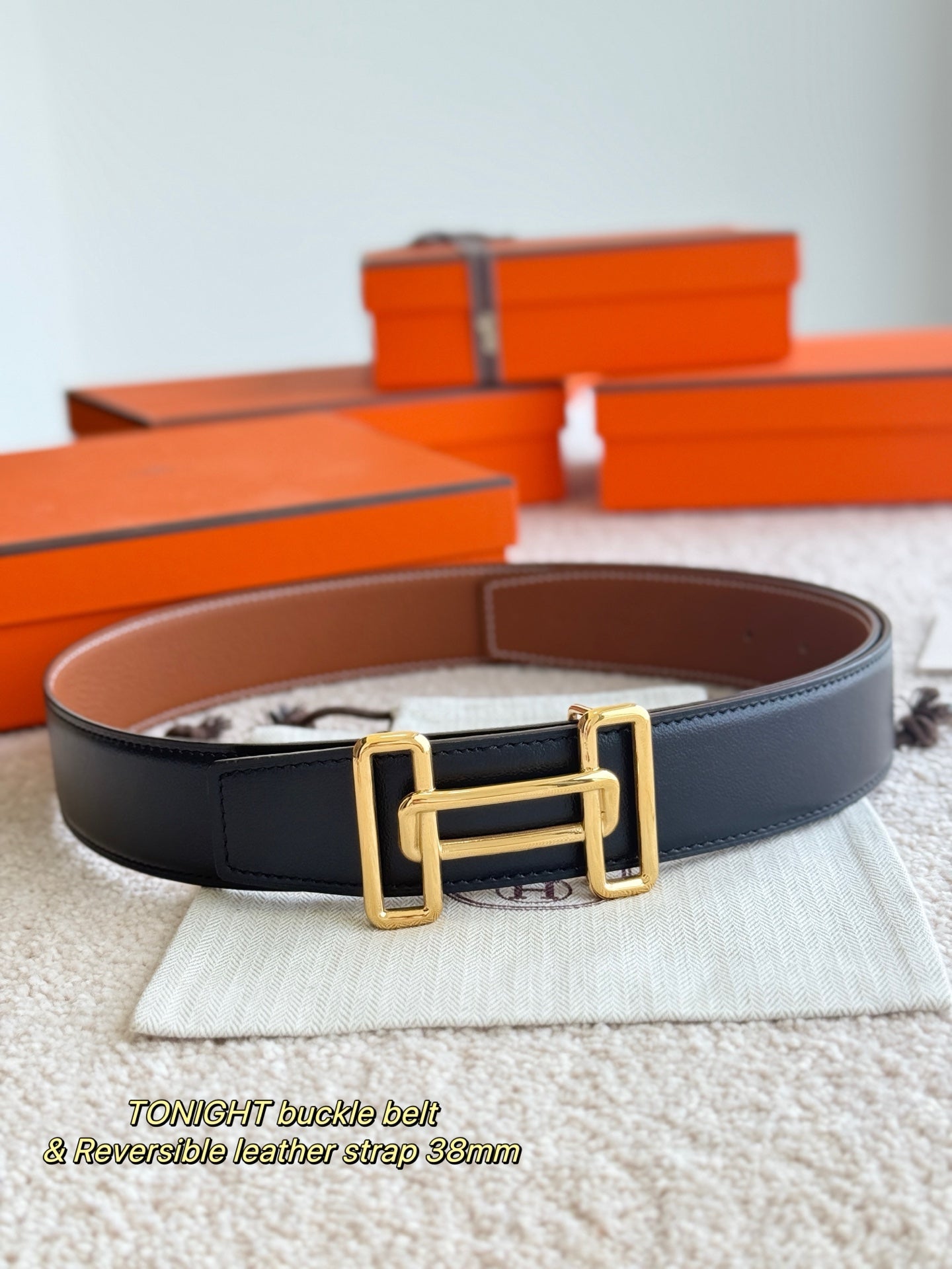 Reversible leather belt with gold-tone double buckle, dark strap with brown interior