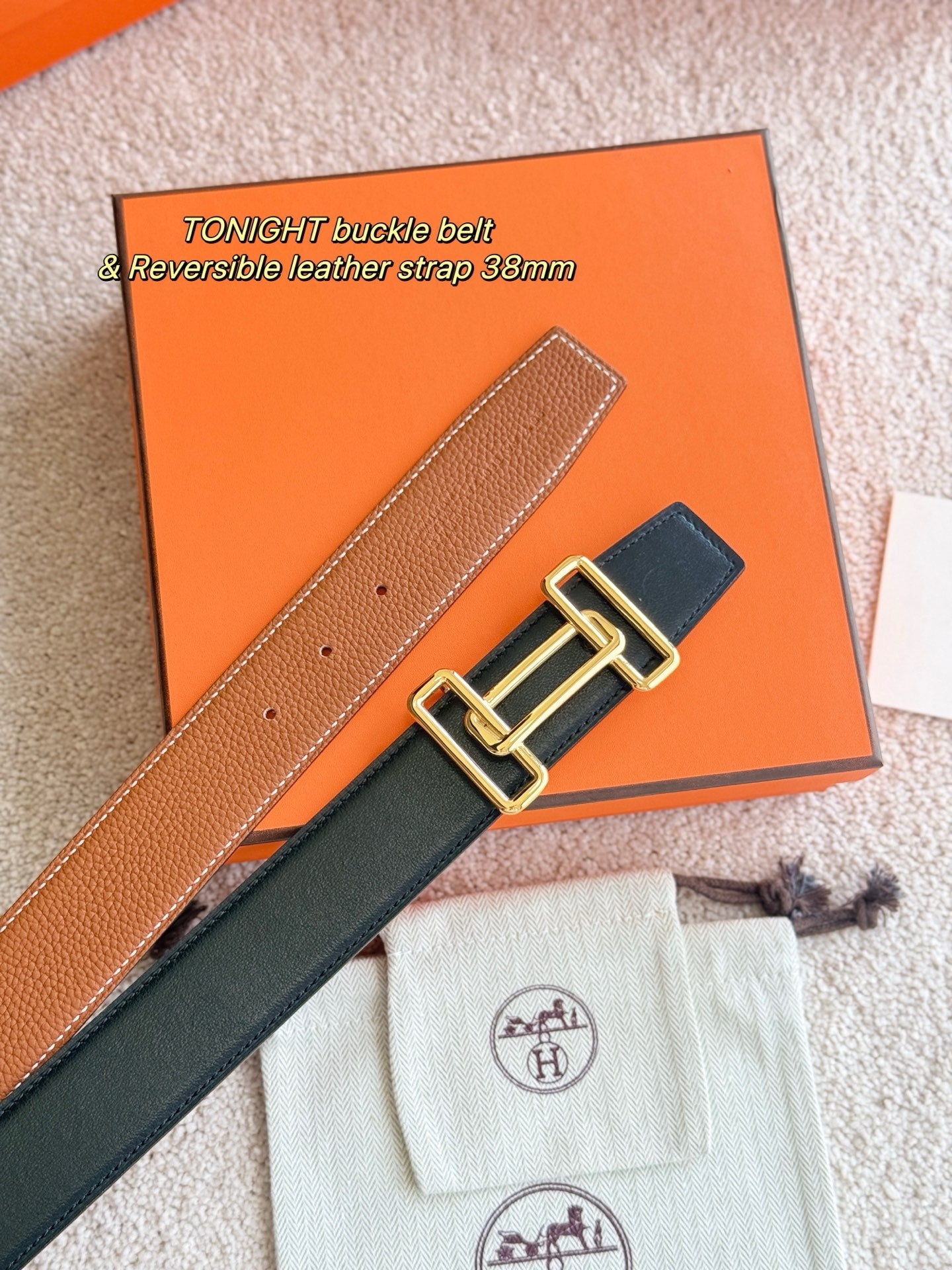 Reversible leather belt with gold-tone buckle, tan strap and dark strap shown