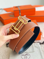 Reversible leather belt with gold-tone buckle, brown strap with dark underside