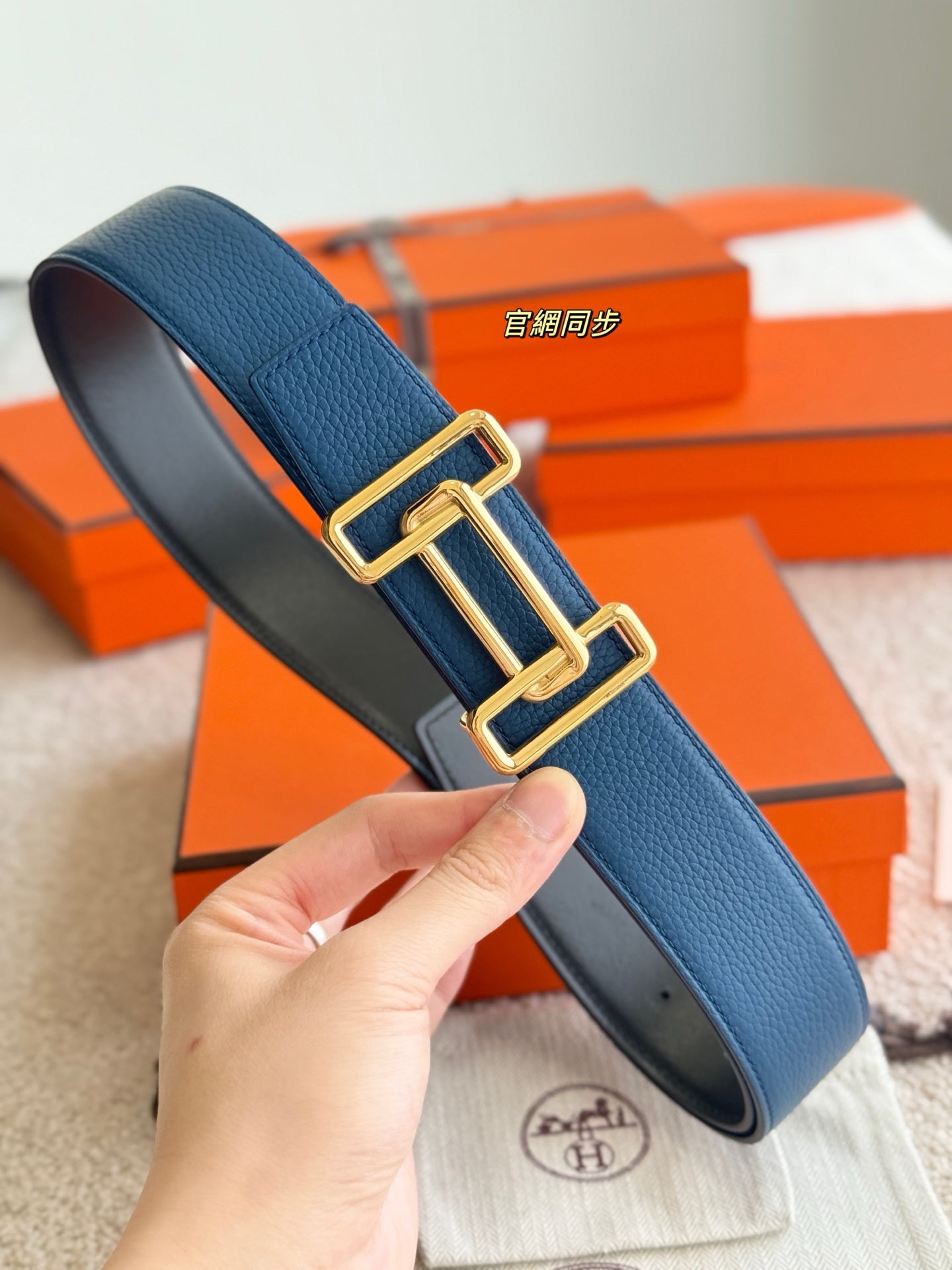 Blue leather belt strap with gold-tone buckle