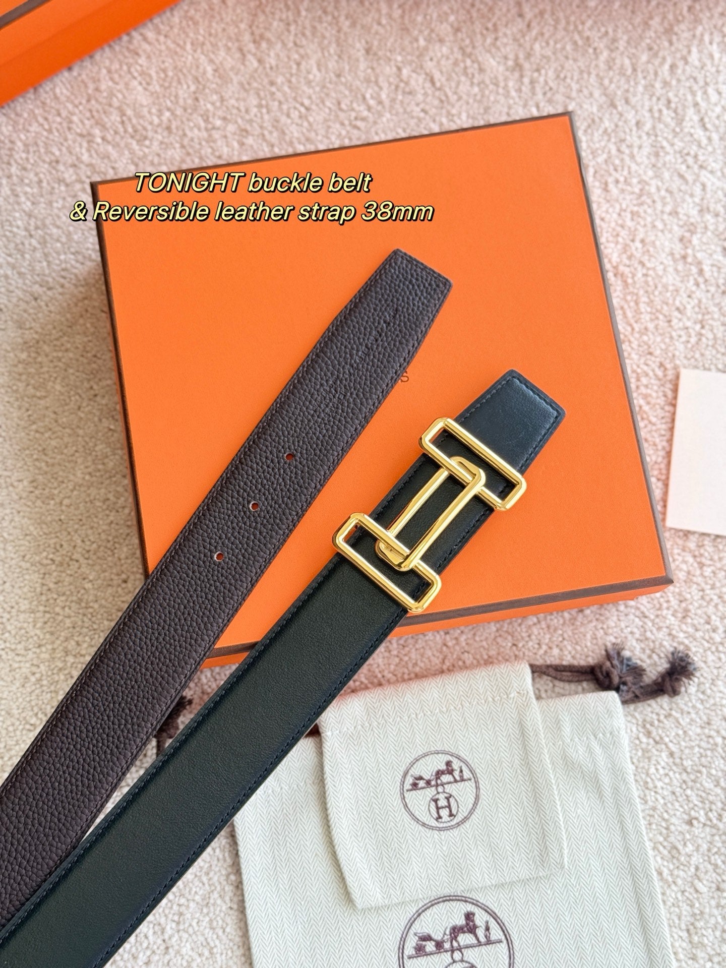 Reversible leather belt showing strap sections and gold double-buckle hardware.