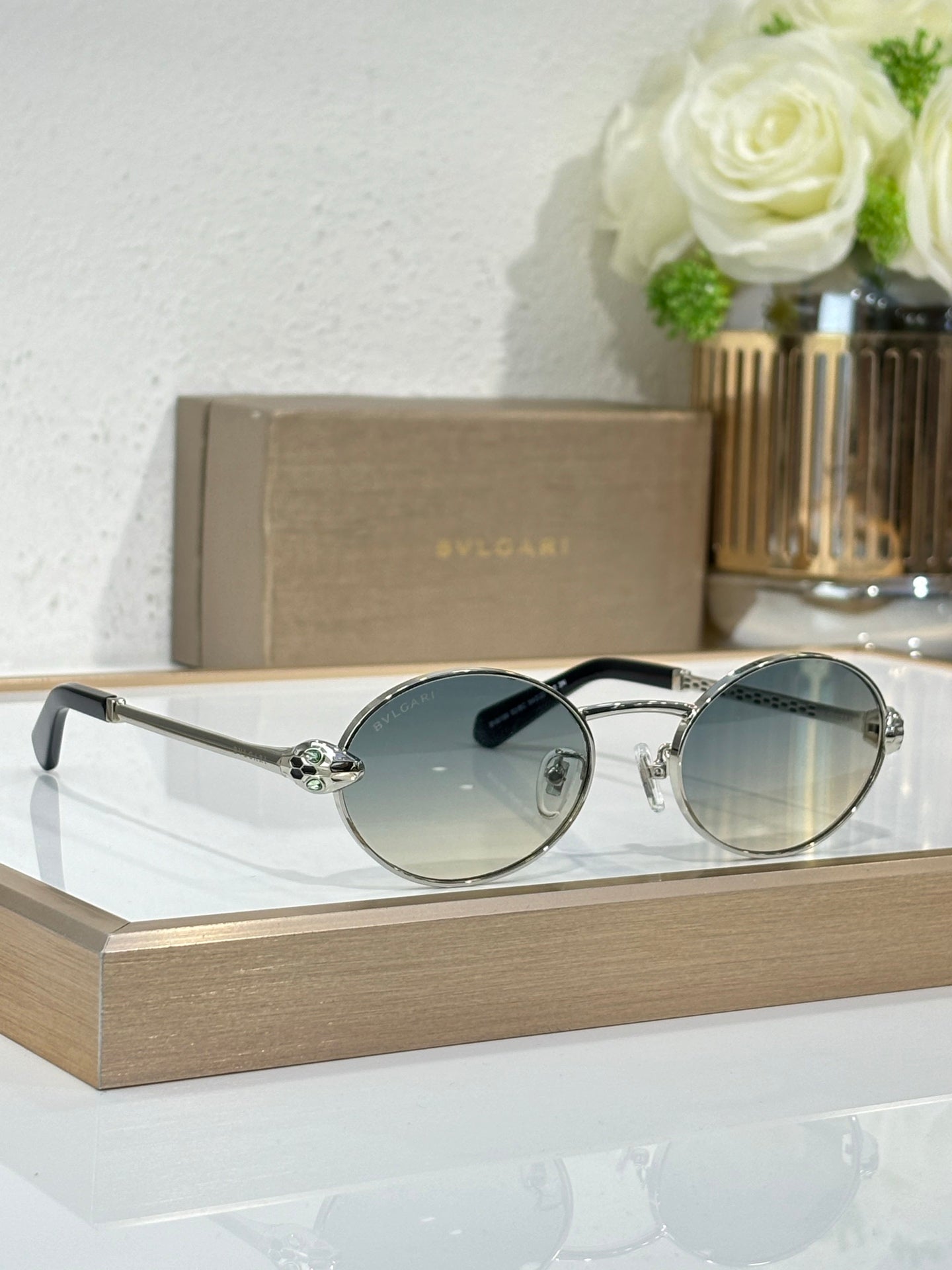 Bvlgari round sunglasses with silver metal frame and blue-tinted lenses
