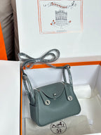Hermes bag, dark teal pebbled leather, top handle and shoulder strap, flap front.