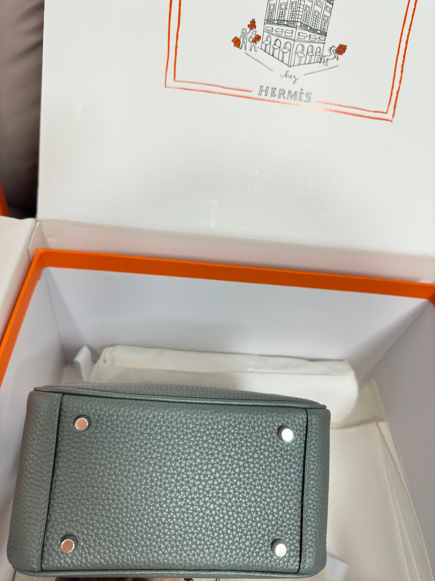 Hermes bag, dark teal pebbled leather, back panel with metal studs, laid in box.