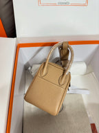Hermes beige leather mini bag with top handle and shoulder strap, flap closure