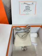 Hermes bag in light beige textured leather with flap and curved top handle
