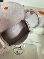 Lilac Hermes handbag top opening with zipper, textured leather and side strap loop