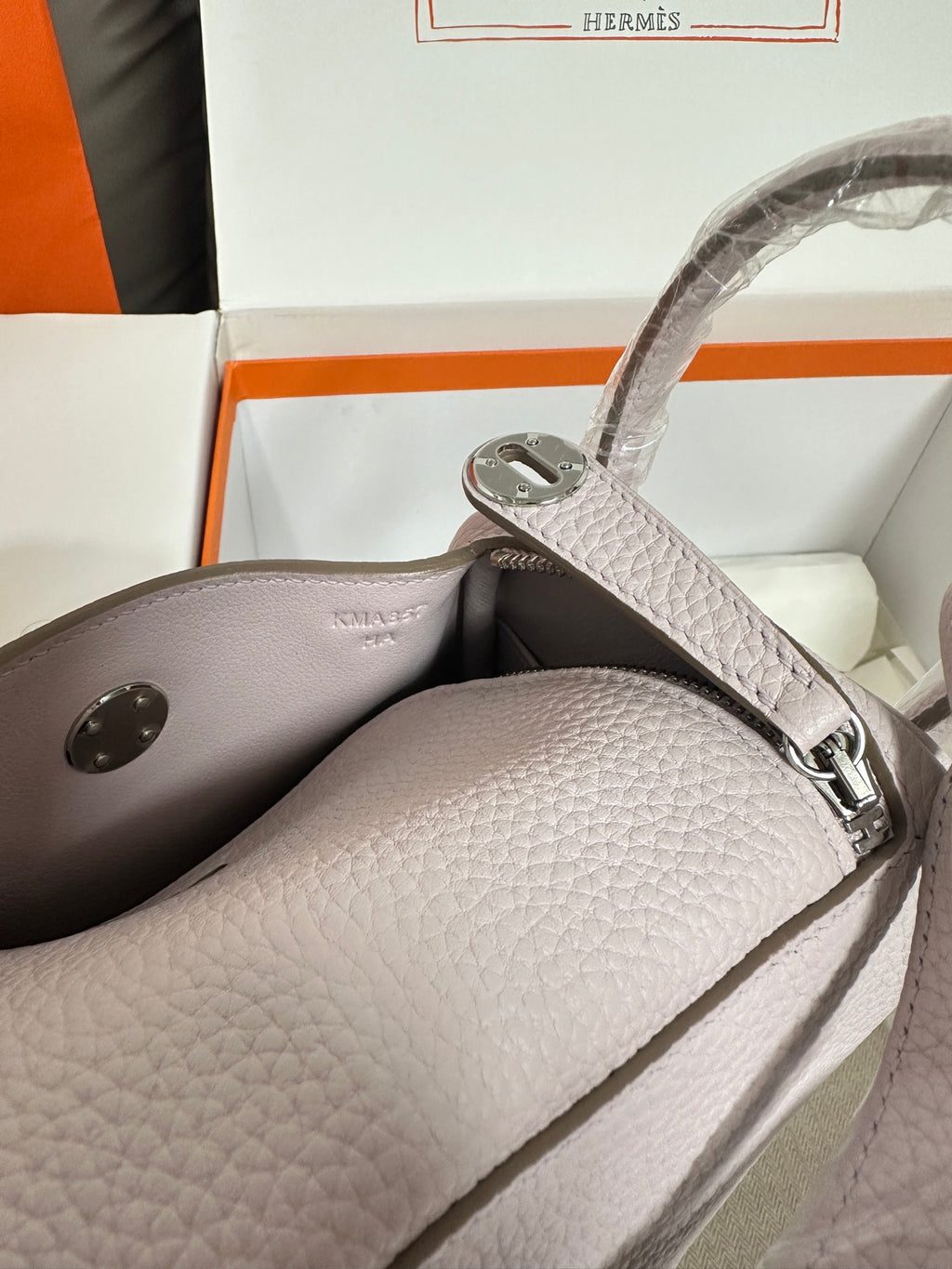 Lilac Hermes handbag interior view with side pocket and silver-tone clasp hardware