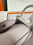 Lilac Hermes handbag interior view with side pocket and silver-tone clasp hardware