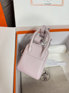 Lilac Hermes mini handbag back panel with two metal feet and top handle loop detail
