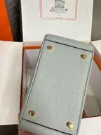 Hermes light blue leather mini bag with two gold studs on back panel