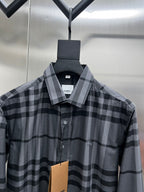 Plaid button-up shirt with gray check pattern, collared front view and partial logo tag