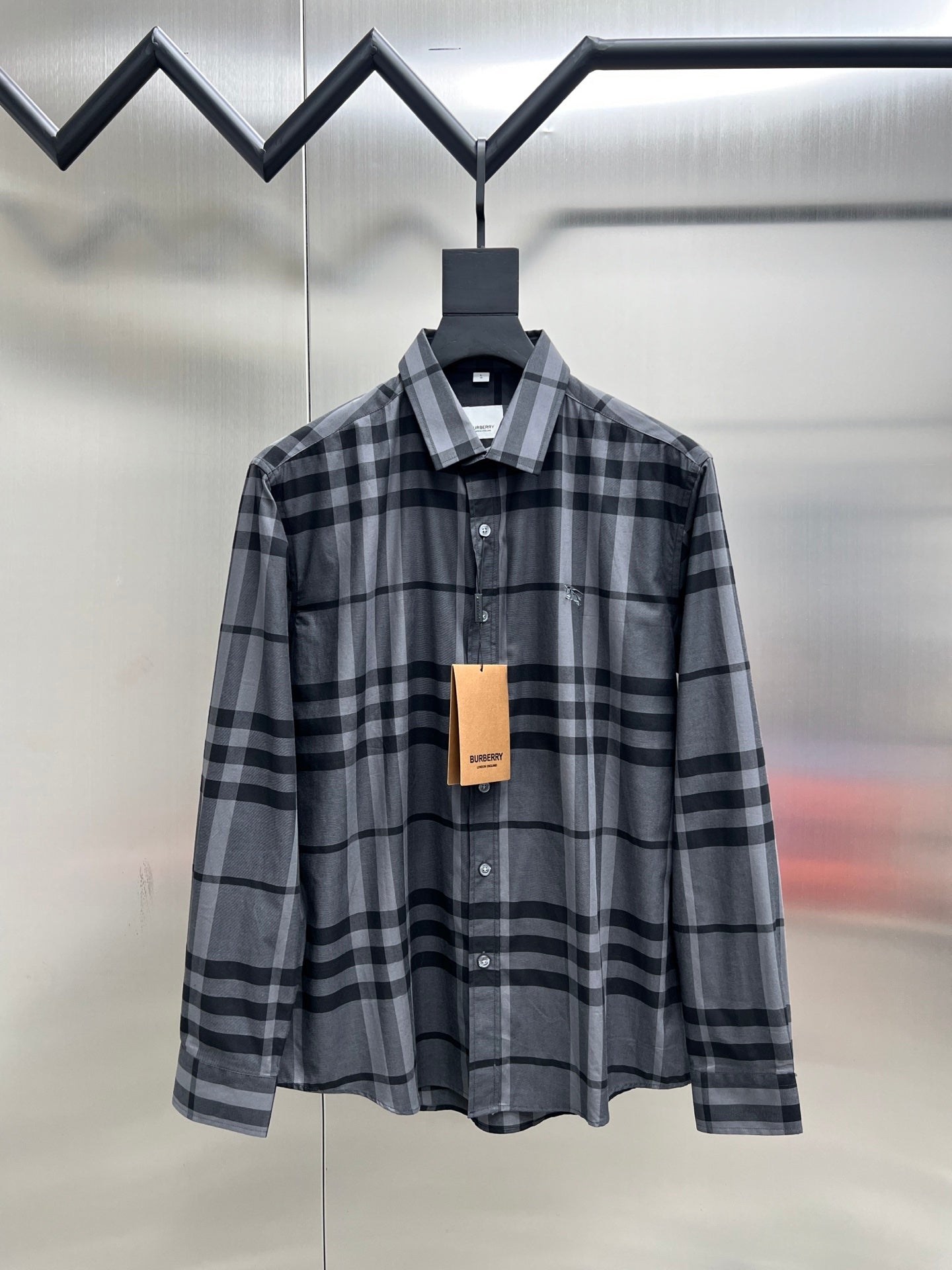 Plaid button-up shirt with dark and light gray check pattern, front view, long sleeves