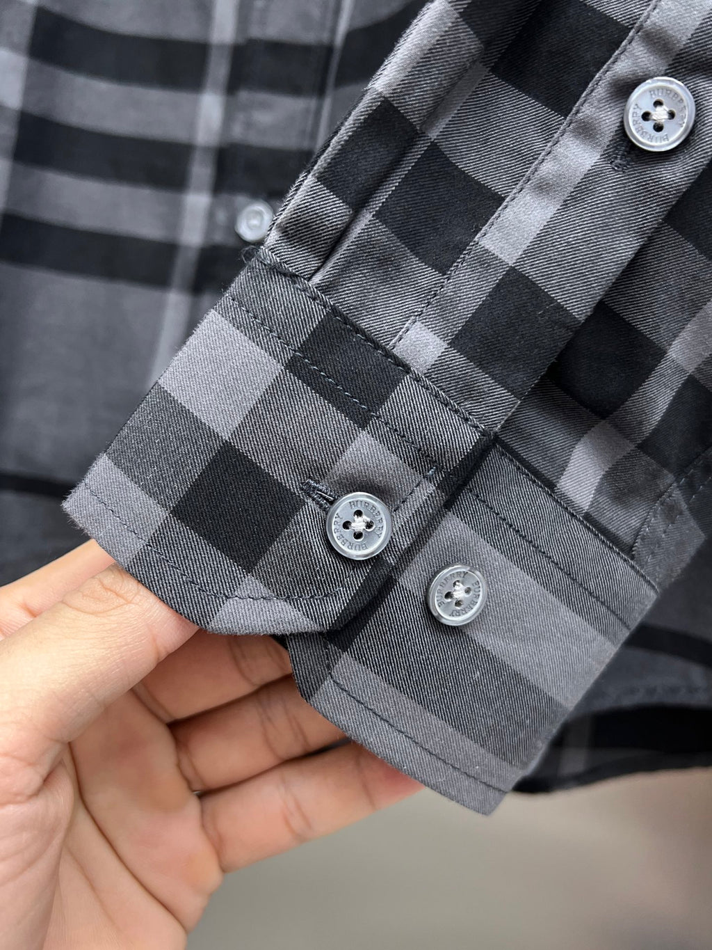 Plaid long-sleeve shirt cuff with three buttons, dark gray and light gray checks