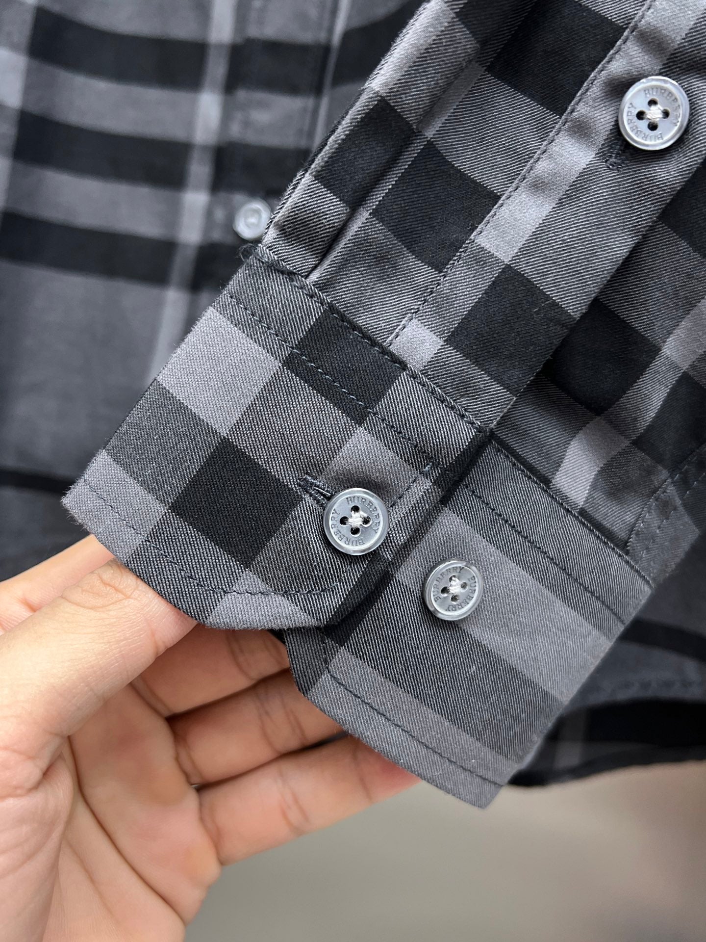 Plaid long-sleeve shirt cuff with three buttons, dark gray and light gray checks