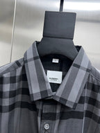 Plaid button-up shirt with gray check pattern, close-up of collar and front buttons